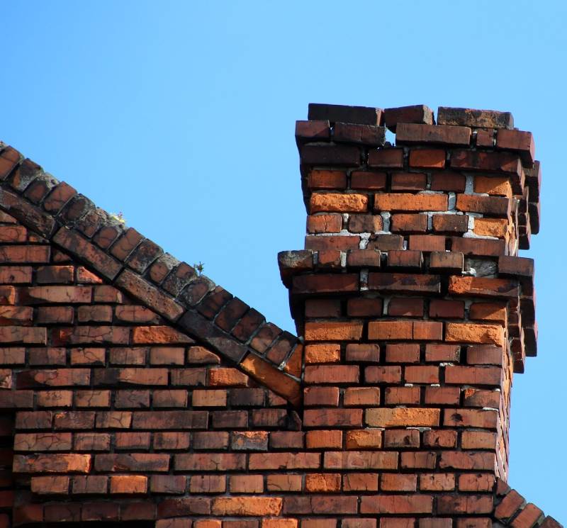 Damaged chimney on an Vernon home showing cracks and missing mortar